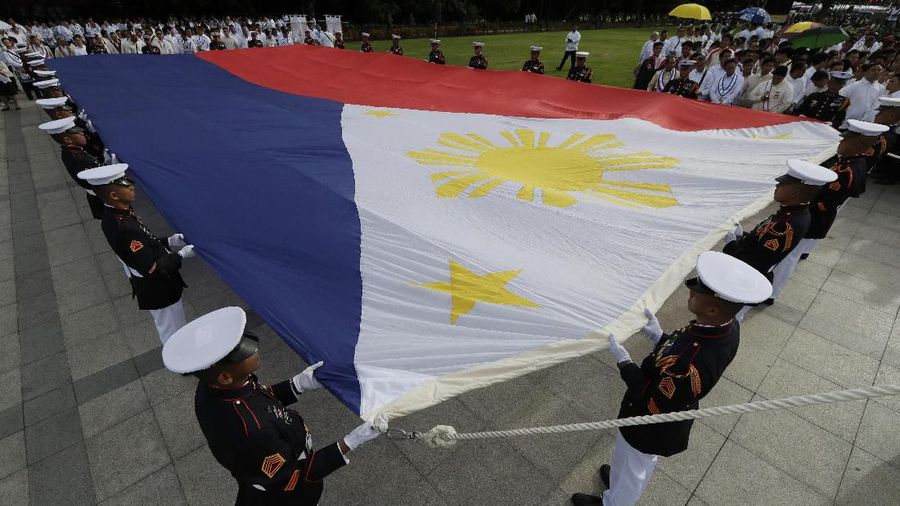 Philippine soldiers carry a giant Philippine flag before ceremonies to mark the 121st anniversary of Philippine independence at Manila's Rizal Park Wednesday, June 12, 2019. (AP Photo/Aaron Favila)