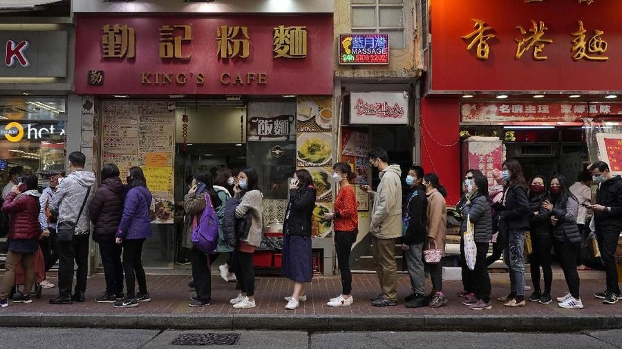 People queue up to buy face masks at a cosmetics shop in Hong Kong, Thursday, Jan. 30, 2020. The death toll rose to 170 in the new virus outbreak in China on Thursday as foreign evacuees from the worst-hit region begin returning home under close observation and world health officials expressed 