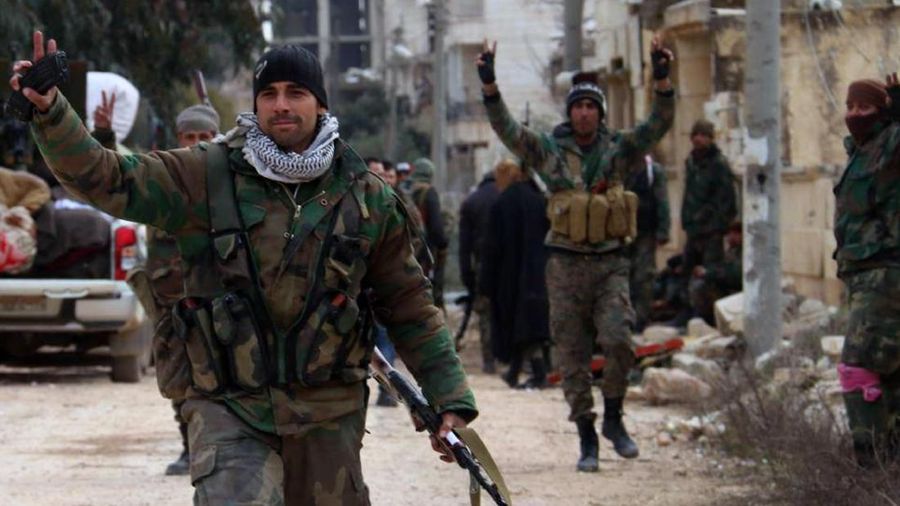 In this photo released Sunday, Feb. 16, 2020 by the Syrian official news agency SANA, Syrian army soldiers flash the victory sign in the Rashideen neighborhood, in Aleppo province, Syria. Syria's military announced on Monday that its troops have regained control of territories in northwestern Syria 