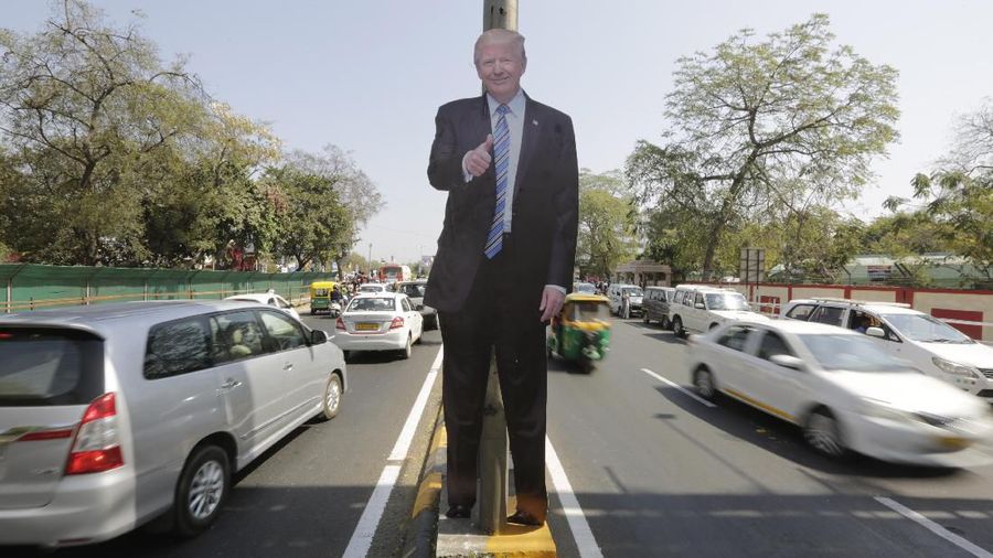 A life size cut-out of U.S. president Donald Trump stands on a road divider, ahead of his visit in Ahmedabad, India, Saturday, Feb. 22, 2020. To welcome Trump, who last year likened Modi to Elvis Presley for his crowd-pulling power at a joint rally the two leaders held in Houston, the Gujarat government has spent almost $14 million on ads blanketing the city that show them holding up their hands, flanked by the Indian and U.S. flags. (AP Photo/Ajit Solanki)