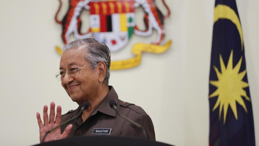 In this April 15, 2019, photo, Malaysian Prime Minister Mahathir Mohamad wave good bye to media after a press conference in Putrajaya. Malaysian Prime Minister Mahathir has tendered his resignation to the king, his office reported Monday, Feb. 24, 2020. (AP Photo/Vincent Thian)