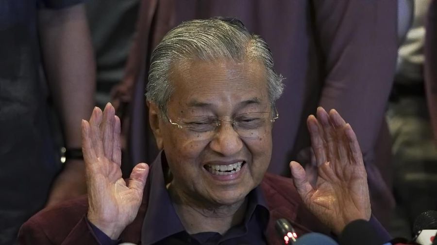 In this Saturday, Feb. 22, 2020, photo, Malaysian Prime Minister Mahathir Mohamad, gesture as he speaks during a press conference in Putrajaya, Malaysia. Mahathir has tendered his resignation to the king, his office reported Monday. (AP Photo/Vincent Thian)