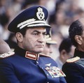 FILE - In this Oct. 6, 1981 file photo, Egyptian President Anwar Sadat, right, and Vice President Hosni Mubarak sit on the reviewing stand during a military parade just before soldiers opened fire from a truck during the parade at the reviewing stand