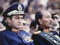 FILE - In this Oct. 6, 1981 file photo, Egyptian President Anwar Sadat, right, and Vice President Hosni Mubarak sit on the reviewing stand during a military parade just before soldiers opened fire from a truck during the parade at the reviewing stand