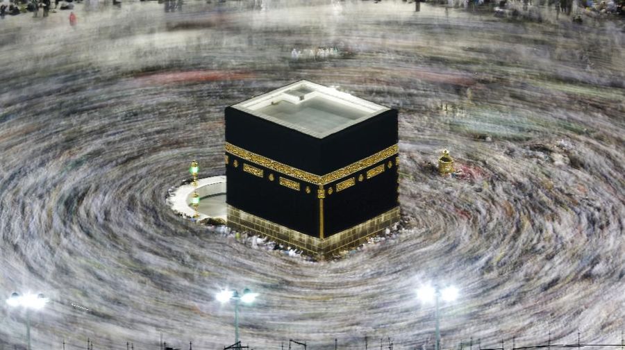 FILE - In this Aug. 13, 2019, file photo taken with a slow shutter speed, Muslim pilgrims circumambulate the Kaaba, the cubic building at the Grand Mosque, during the hajj pilgrimage in the Muslim holy city of Mecca, Saudi Arabia. Saudi Arabia on Thursday, Feb. 27, 2020, halted travel to the holiest sites in Islam over fears of the global outbreak of the new coronavirus just months ahead of the annual hajj pilgrimage, a move coming as the Mideast has over 220 confirmed cases of the illness. (AP Photo/Amr Nabil, File)