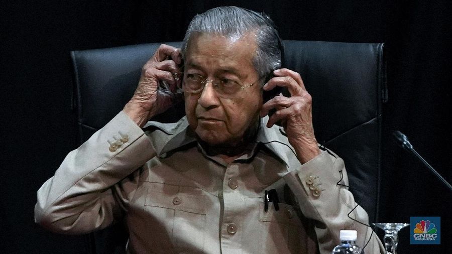 Malaysia's interim leader Mahathir Mohamad adjusts his headphone as he attends the committee on the exercise of the inalienable rights of the Palestinian people, in Kuala Lumpur, Malaysia, Friday, Feb. 28, 2020. The speaker of Malaysia's House rejected Mahathir Mohamad's call for a vote next week to chose a new premier, deepening the country's political turmoil after the ruling alliance collapsed this week. (AP Photo/Vincent Thian)