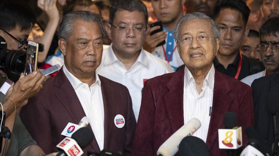 In this May 9, 2018, photo, Mahathir Mohamad, right, speaks to media during a press conference to announce victory on election as Muhyiddin Yassin, president of Malaysian United Indigenous Party stands next to him at a hotel in Kuala Lumpur, Malaysia. Bersatu party said in a statement Friday, Feb. 28, 2020 that 36 lawmakers, including nearly a dozen who defected from Anwar Ibrahim's party, have decided to support party President Muhyiddin Yassin instead of Mahathir as prime minister. (AP Photo/Vincent Thian)