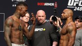 UFC middleweight champion Israel Adesanya, left, of Nigeria, and challenger Yoel Romero, of Cuba, face off during a ceremonial weigh-in for UFC 248 at T-Mobile Arena in Las Vegas, Friday, March 6, 2020. Adesanya will defend his title at the arena on Saturday, March 7. (Steve Marcus/Las Vegas Sun via AP)