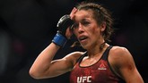 Joanna Jedrzejczyk menyentuh dahi yang benjol usai pertarungan melawan Zhang Weili. (Harry How/Getty Images/AFP)