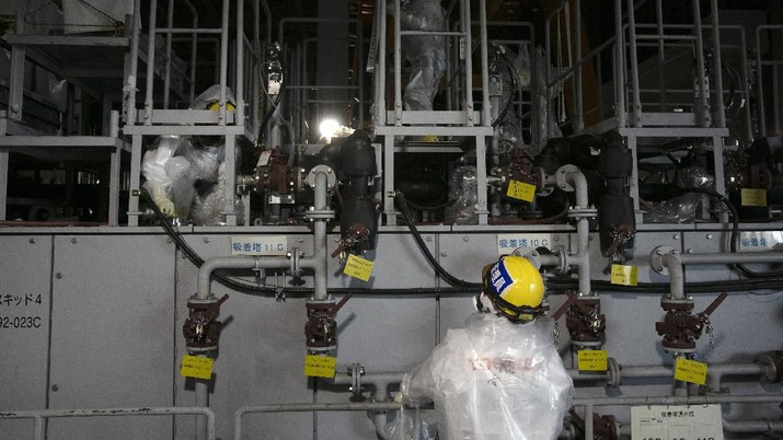 In this Feb. 12, 2020, photo, the Unit 1 and 2 reactor buildings, damaged by the 2011 earthquake and tsunami, are seen at the Fukushima Dai-ichi nuclear power plant in Okuma, Fukushima Prefecture, Japan. Nine years ago, on March 11, 2011, a magnitude 9.0 quake and tsunami destroyed key cooling functions at the plant, causing a meltdown that leaked a massive amount of radiation and forcing some 160,000 residents to evacuate. About 40,000 of them still haven't returned. (AP Photo/Jae C. Hong)