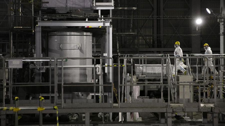 In this Feb. 12, 2020, photo, the Unit 1 and 2 reactor buildings, damaged by the 2011 earthquake and tsunami, are seen at the Fukushima Dai-ichi nuclear power plant in Okuma, Fukushima Prefecture, Japan. Nine years ago, on March 11, 2011, a magnitude 9.0 quake and tsunami destroyed key cooling functions at the plant, causing a meltdown that leaked a massive amount of radiation and forcing some 160,000 residents to evacuate. About 40,000 of them still haven't returned. (AP Photo/Jae C. Hong)
