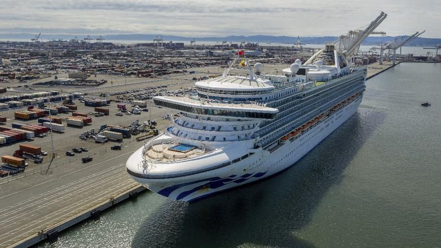 Tents stand on a wharf near the Grand Princess at the Port of Oakland in Oakland, Calif., Monday, March 9, 2020. The cruise ship, which had maintained a holding pattern off the coast for days, is carrying multiple people who tested positive  for COVID-19, a disease caused by the new coronavirus. (AP Photo/Noah Berger)