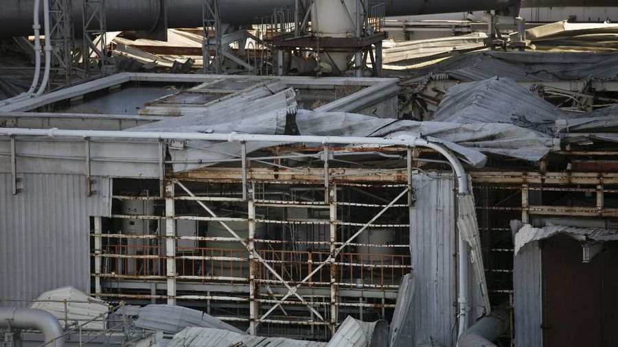 In this Feb. 12, 2020, photo, the Unit 1 and 2 reactor buildings, damaged by the 2011 earthquake and tsunami, are seen at the Fukushima Dai-ichi nuclear power plant in Okuma, Fukushima Prefecture, Japan. Nine years ago, on March 11, 2011, a magnitude 9.0 quake and tsunami destroyed key cooling functions at the plant, causing a meltdown that leaked a massive amount of radiation and forcing some 160,000 residents to evacuate. About 40,000 of them still haven't returned. (AP Photo/Jae C. Hong)