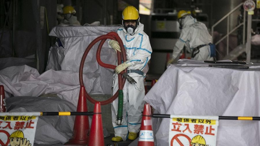 In this Feb. 12, 2020, photo, the Unit 1 and 2 reactor buildings, damaged by the 2011 earthquake and tsunami, are seen at the Fukushima Dai-ichi nuclear power plant in Okuma, Fukushima Prefecture, Japan. Nine years ago, on March 11, 2011, a magnitude 9.0 quake and tsunami destroyed key cooling functions at the plant, causing a meltdown that leaked a massive amount of radiation and forcing some 160,000 residents to evacuate. About 40,000 of them still haven't returned. (AP Photo/Jae C. Hong)