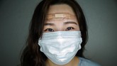 Representatif rumah sakit, Jung Sang-min mengatakan butuh waktu sekitar setengah jam untuk memakai pakaian pelindung perawat. Dia juga bilang lebih banyak perawat yang mengenakan perban ketimbang dokter, hal itu menandakan perawat lebih banyak menghabiskan waktu dengan pasien. (Photo by Ed JONES / AFP)