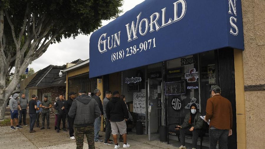 Gun store patrons wait in line, Sunday, March 15, 2020, in Burbank, Calif. Consumers are buying all kinds of goods in large quantities amid coronavirus concerns, putting pressure on inventories. Some people in line simply wanted to stock up on ammunition, while others said they were preparing in case their homes get invaded for food and other necessities. (AP Photo/Mark J. Terrill)