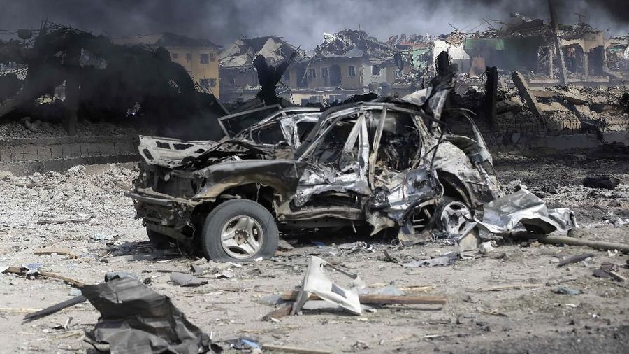 People gather near the site of an explosion in Lagos, Nigeria. Sunday March 15, 2020. An explosion hit Nigeria's commercial capital of Lagos early Sunday, killing at least 15 people and sparking search-and- rescue efforts to save people still trapped in collapsed buildings, emergency officials said. (AP Photos/Sunday Alamba)