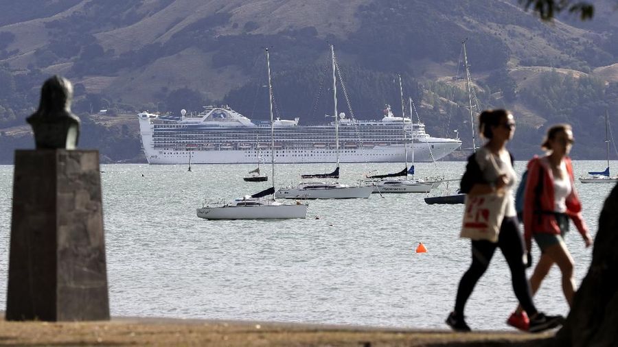 The Golden Princess sits at anchor off shore from Akaroa in the South Island of New Zealand, Sunday, March 15, 2020. Passengers aboard the cruise ship were not being allowed off the boat while three passengers were tested for the new coronavirus. For most people, the new coronavirus causes only mild or moderate symptoms. For some it can cause more severe illness. (AP Photo/Mark Baker)