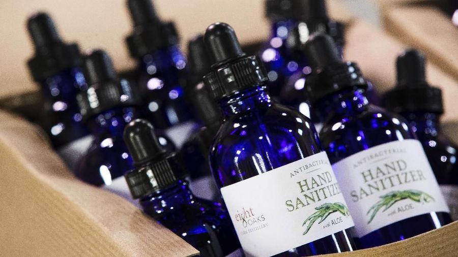 Bottles of hand sanitizer made at the Eight Oaks Farm Distillery sit in a display box at the distillery in New Tripoli, Pa., Monday, March 16, 2020. The distillery's owner, Chad Butters, grew increasingly angry as he saw the skyrocketing price of hand sanitizer. So he's temporarily converting his operation into a production line for the suddenly hard-to-find, gooey, alcohol-based disinfectant. (AP Photo/Matt Rourke)