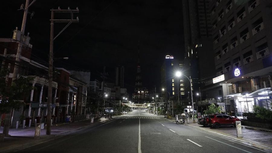 An empty street shortly past midnight at Quezon city in Manila, Philippines early Tuesday, March 17, 2020 as the government implements an 