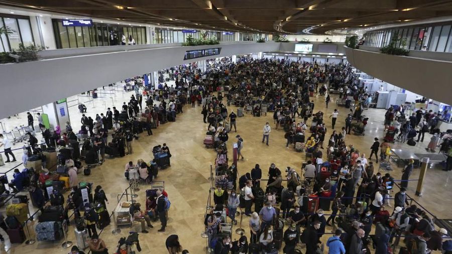 In this handout photo provided by the Manila International Airport Authority (MIAA) Media Affairs, passengers wait for their flight at the departure area of Manila's International Airport, Philippines on Tuesday Mar. 17, 2020, while the government implements a localized quarantine as a precautionary measure against the spread of the new coronavirus. Land, air and sea travel will be restricted under the monthlong containment. For most people, the new coronavirus causes only mild or moderate symptoms. For some, it can cause more severe illness, especially in older adults and people with existing health problems. (MIAA Media Affairs via AP)