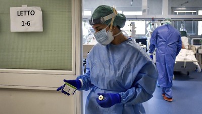 A nurse leaves the intensive care unit of the hospital of Brescia, Italy, Thursday, March 19, 2020. Italy has become the country with the most coronavirus-related deaths, surpassing China by registering 3,405 dead. Italy reached the gruesome milestone on the same day the epicenter of the pandemic, Wuhan, China, recorded no new infections. For most people, the new coronavirus causes only mild or moderate symptoms. For some it can cause more severe illness. (Claudio Furlan/LaPresse via AP)