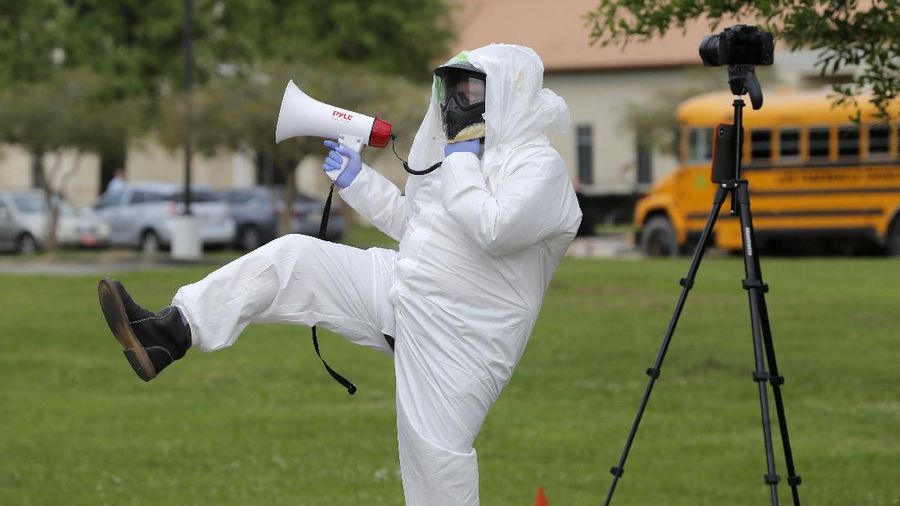 Lance Knippers protests outside as congregants arrive for services at the Life Tabernacle Church in Central, La., Sunday, March 29, 2020. Pastor Tony Spell has defied a shelter-in-place order by Louisiana Gov. John Bel Edwards, due to the new coronavirus pandemic, and continues to hold church services with hundreds of congregants. (AP Photo/Gerald Herbert)
