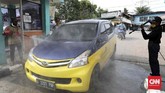 Gerbang masuk sebuah area dadakan diubah menjadi tempat penyemprotan disinfektan bagi warga yang datang dengan kendaraan roda empat. (CNNIndonesia/Safir Makki)