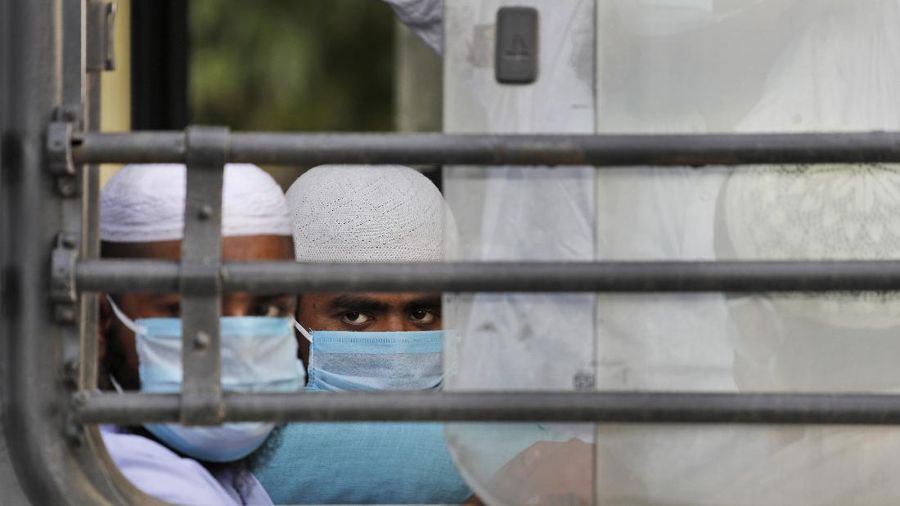Muslim pilgrims wait in bus that will take them to a quarantine facility, amid concerns over the spread of the new coronavirus, at the Nizamuddin area of New Delhi, India, Tuesday, March 31, 2020. Police has cordoned off the area after several people who attended an Islamic congregation earlier this month here tested positive for Covid-19. The new coronavirus causes mild or moderate symptoms for most people, but for some, especially older adults and people with existing health problems, it can cause more severe illness or death. (AP Photo/Manish Swarup)