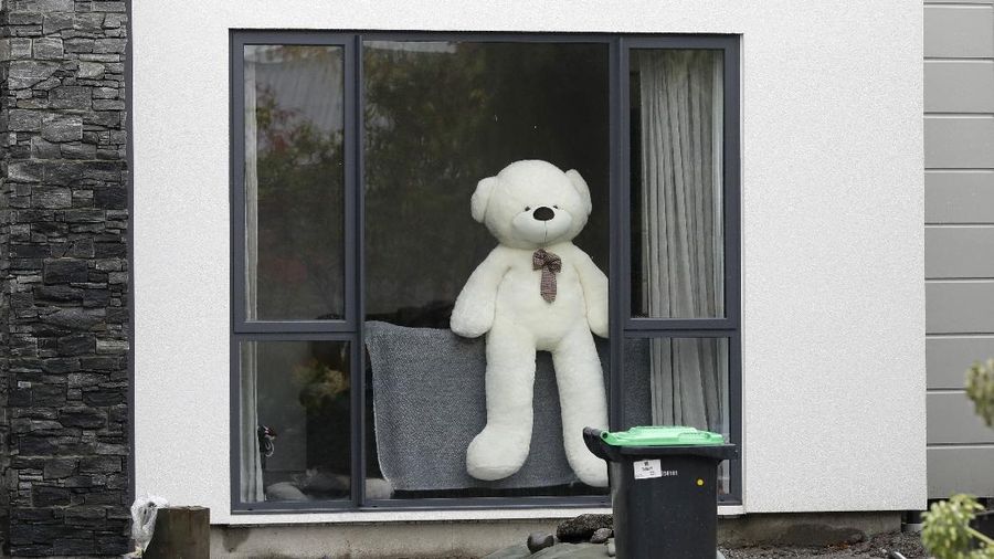 In this Monday, March 30, 2020, photo, a teddy bear sits in a window of a house in Christchurch, New Zealand. New Zealanders are embracing an international movement in which people are placing teddy bears in their windows during coronavirus lockdowns to brighten the mood and give children a game to play by spotting the bears in their neighborhoods. (AP Photo/Mark Baker)