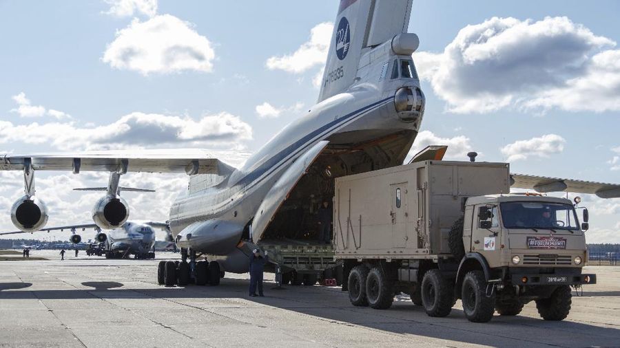 In this photo taken on Sunday, March 22, 2020, and distributed by Russian Defense Ministry Press Service, a military truck loads on board of an Il-76 cargo plane in Chkalovsky military airport outside Moscow, Russia. Nine hulking Il-76 cargo planes are being loaded at the Chkalovsky military airport in Moscow as Russia prepares to send medical personnel and supplies to Italy to help the country's efforts against the coronavirus. The mission include eight mobile medical teams along with medical equipment and aerosol disinfection trucks is to begin Sunday, one day after Russian President Vladimir Putin offered the aid in a telephone conversation with Italian Prime Minister Giuseppe Conte, whose country has confirmed more than 53,000 coronavirus cases and over 4,800 deaths. (Alexei Yereshko, Russian Defense Ministry Press Service via AP)