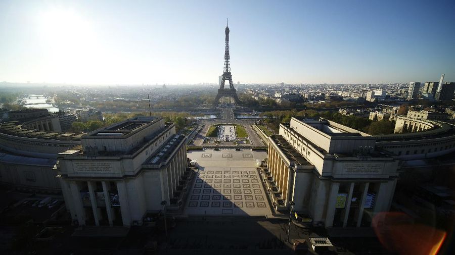 This photo taken Sunday April 5, 2020 shows the Eiffel Tower in background during the nationwide confinement due to the coronavirus outbreak in Paris. The new coronavirus causes mild or moderate symptoms for most people, but for some, especially older adults and people with existing health problems, it can cause more severe illness or death. (AP Photo/Lesdronographes)