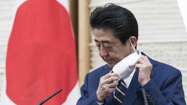 Japan's Prime Minister Shinzo Abe gestures during a press conference at the prime minister's official residence Tuesday, April 7, 2020, in Tokyo. Abe declared a state of emergency for Tokyo and six other prefectures to ramp up defenses against the spread of the coronavirus. (Tomohiro Ohsumi/Pool Photo via AP)