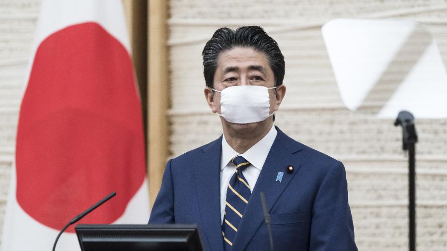 Japan's Prime Minister Shinzo Abe gestures during a press conference at the prime minister's official residence Tuesday, April 7, 2020, in Tokyo. Abe declared a state of emergency for Tokyo and six other prefectures to ramp up defenses against the spread of the coronavirus. (Tomohiro Ohsumi/Pool Photo via AP)
