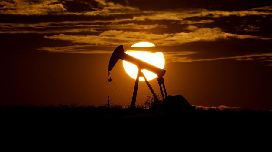 The sun sets behind an idle pump jack near Karnes City, Texas, Wednesday, April 8, 2020. Demand for oil continues to fall due to the new coronavirus outbreak. (AP Photo/Eric Gay)