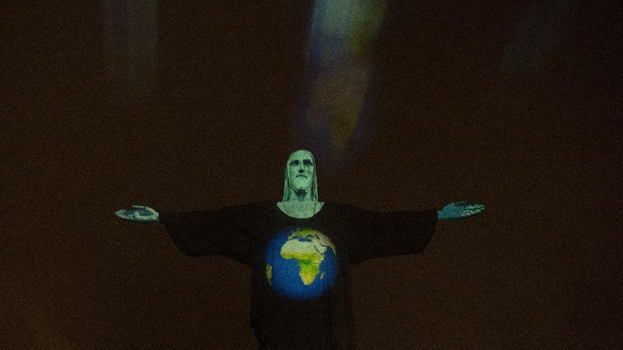 Rio's Christ the Redeemer statue is lit up with an image of the earth, as a way to show support for those afflicted by the new coronavirus, in Rio de Janeiro, Brazil, Wednesday, March 18, 2020. For most people COVID-19 causes mild or moderate symptoms. For others, especially the elderly and people with existing health problems, it can cause many other serious illnesses, including pneumonia. (AP Photo/Silvia Izquierdo)