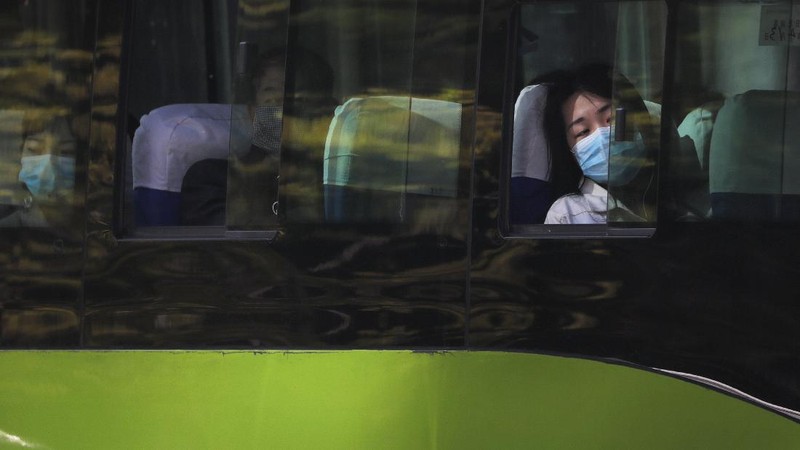 Commuters wear face masks to protect against the spread of new coronavirus as they walk through a subway station in Beijing, Thursday, April 9, 2020. China's National Health Commission on Thursday reported dozens of new COVID-19 cases, including most of which it says are imported infections in recent arrivals from abroad and two 