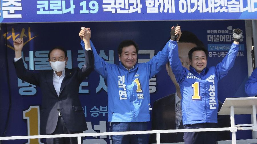 The ruling Democratic Party's supporters wearing face masks to help protect against the spread of the new coronavirus wave their hands during a campaign for the upcoming parliamentary election in Seoul, South Korea, Tuesday, April 14, 2020. The elections will be held on April 15 at about 14,300 polling stations all over the nation to pick lawmakers.(AP Photo/Ahn Young-joon)