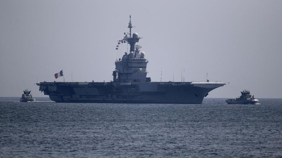 The French aircraft carrier Charles de Gaulle arrives in the bay of Toulon, southern France, Sunday April 12, 2020. The Defense Ministry said in a statement that around 40 sailors showed symptoms compatible with COVID-19, the disease the coronavirus causes. The new coronavirus causes mild or moderate symptoms for most people, but for some, especially older adults and people with existing health problems, it can cause more severe illness or death. (AP Photo/Daniel Cole)