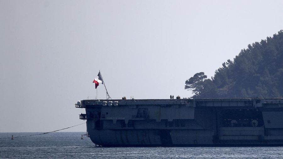 The French aircraft carrier Charles de Gaulle arrives in the bay of Toulon, southern France, Sunday April 12, 2020. The Defense Ministry said in a statement that around 40 sailors showed symptoms compatible with COVID-19, the disease the coronavirus causes. The new coronavirus causes mild or moderate symptoms for most people, but for some, especially older adults and people with existing health problems, it can cause more severe illness or death. (AP Photo/Daniel Cole)
