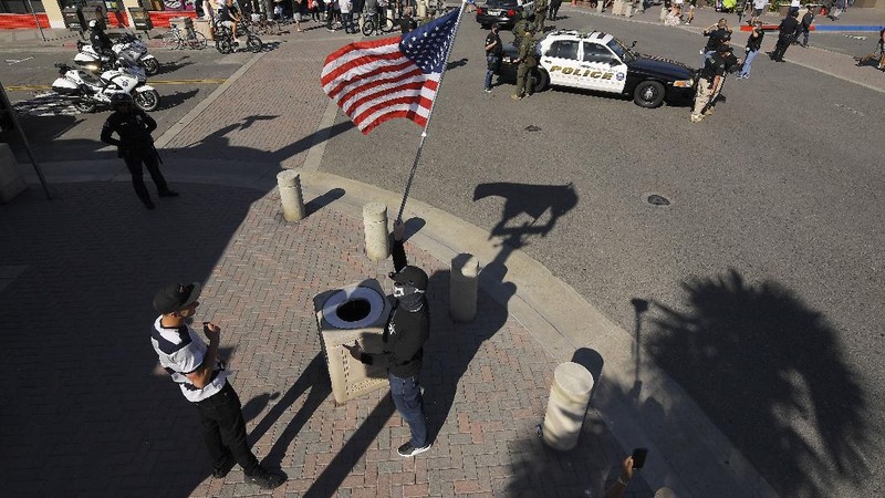 Protesters demonstrate against stay-at-home orders that were put in place due to the COVID-19 outbreak, Friday, April 17, 2020, in Huntington Beach, Calif. (AP Photo/Mark J. Terrill)
