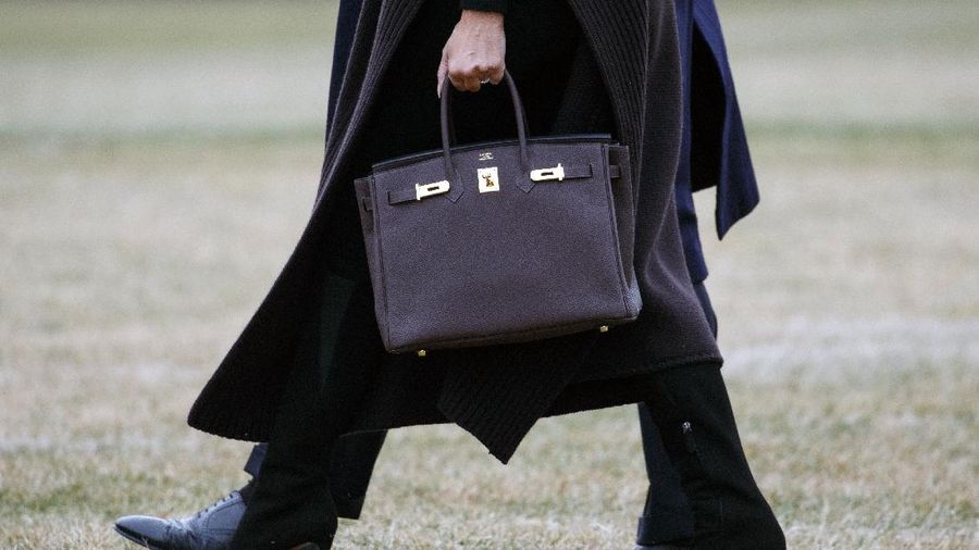 President Donald Trump and first lady Melania Trump, carrying a Hermes handbag, walk to Marine One across the South Lawn of the White House in Washington, Friday, Feb. 15, 2019, for the short trip to Andrews Air Force Base en route to Palm Beach International Airport, in West Palm Beach, Fla., then to Mar-a-Lago. (AP Photo/Carolyn Kaster)