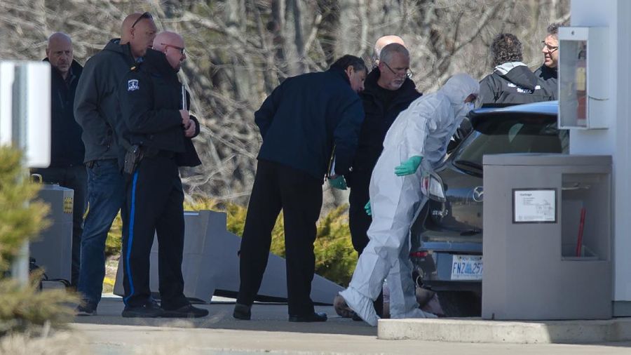 Royal Canadian Mounted Police officers surround a suspect at a gas station in Enfield, Nova Scotia, Sunday April 19, 2020. Canadian police say multiple people are dead plus the suspect after a shooting rampage across the province of Nova Scotia. It was the deadliest shooting in Canada in 30 years. (Tim Krochak/The Canadian Press via AP)