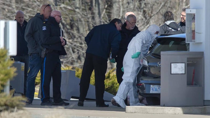 Royal Canadian Mounted Police officers surround a suspect at a gas station in Enfield, Nova Scotia, Sunday April 19, 2020. Canadian police say multiple people are dead plus the suspect after a shooting rampage across the province of Nova Scotia. It was the deadliest shooting in Canada in 30 years. (Tim Krochak/The Canadian Press via AP)