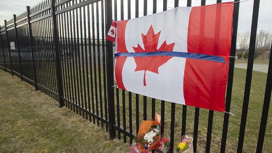 Royal Canadian Mounted Police officers surround a suspect at a gas station in Enfield, Nova Scotia, Sunday April 19, 2020. Canadian police say multiple people are dead plus the suspect after a shooting rampage across the province of Nova Scotia. It was the deadliest shooting in Canada in 30 years. (Tim Krochak/The Canadian Press via AP)