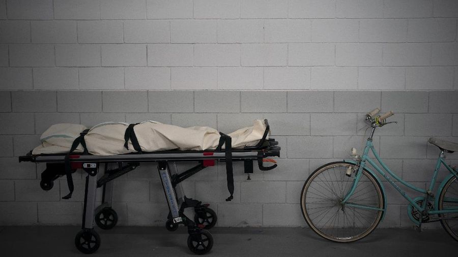 A man sleeps in an empty street during the coronavirus outbreak in Barcelona, Spain, April 17, 2020. (AP Photo/Emilio Morenatti)