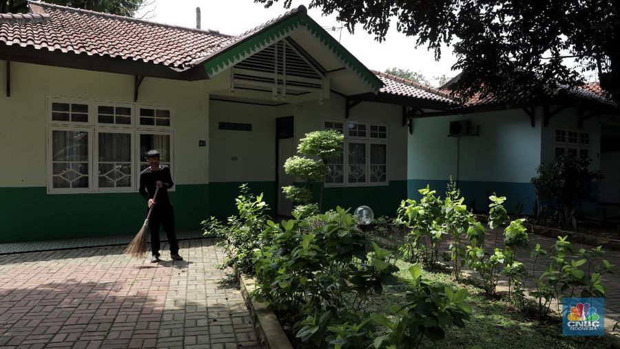 Petugas merapikan ruangan yang akan dijadikan tempat tinggal sementara bagi tenaga medis penanganan Covid-19 di SMKN 57 Jakarta, Rabu (22/4) (CNBC Indonesia/Muhammad Sabki)