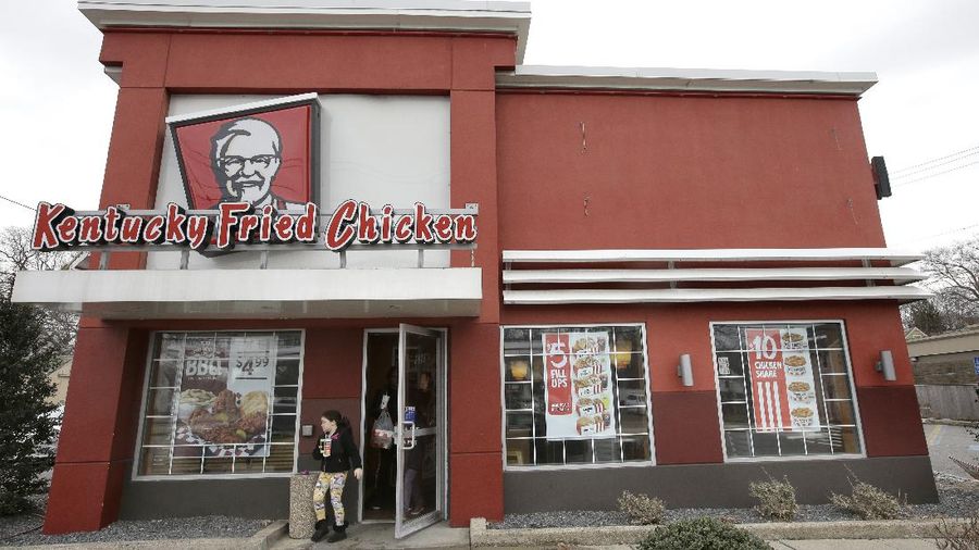 In this Friday, Feb. 23, 2018 photo a person departs a Kentucky Fried Chicken fast food restaurant, in Boston. (AP Photo/Steven Senne)