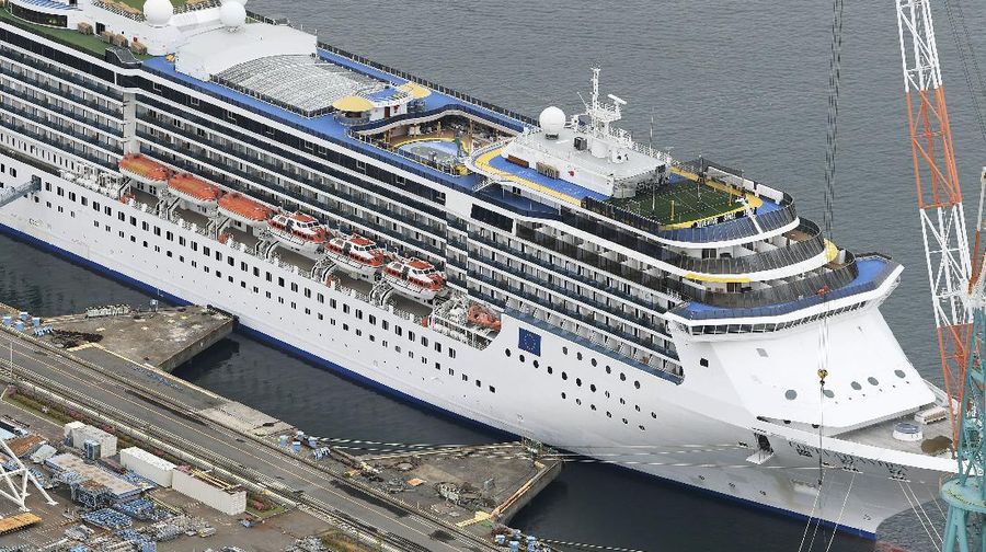 Italian-operated cruise ship the Costa Atlantica is anchored at a port in Nagasaki, southern Japan, Thursday, April 23, 2020. The Costa Atlantica docked since late January is struck by an onboard coronavirus outbreak in which dozens of crew members found to have infected, sending health officials in the southern Japanese city almost free of the virus scrambling to find clues to how the infections started on the ship. (Kyodo News via AP)