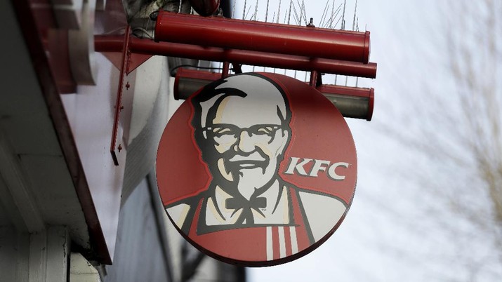A logo on a sign is displayed above a temporarily closed branch of KFC, with a notice on the door stating they have had a delivery hiccup, in the Surbiton suburb of south west, London, Wednesday, Feb. 21, 2018. Chicken is still as scarce as hen's teeth at KFC's British outlets. KFC says about 470 of the fried chicken chain's 900 U.K. restaurants remained closed Tuesday because of a chicken shortage. The company says the disruption started last week, when it changed its delivery provider to DHL. (AP Photo/Matt Dunham)
